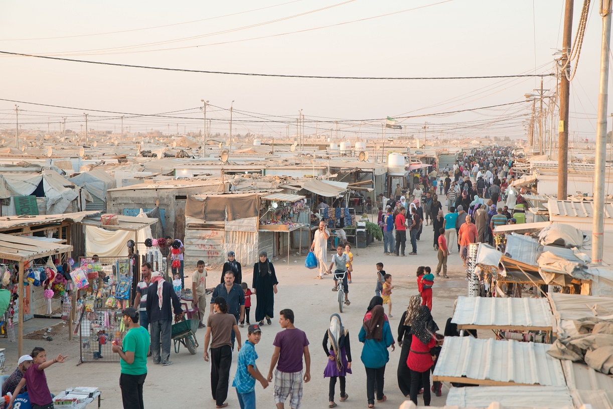 Jordan / Za'atari Camp / The main market street of Za'atari refugee camp, known by aid workers and the international press by the name Champs D'Elyse due to a sign at the French hospital which anchors the street, bustles with activity - especially in the late afternoon and evening hours. 3 September, 2013 / UNHCR / Jared Kohler / September 2013
