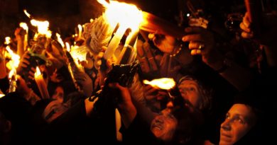 Christian pilgrims hold candles at the Church of the Holy Sepulchre, traditionally believed to be the burial site of Jesus Christ, during the ceremony of the Holy Fire in Jerusalem's Old City, Saturday, April 14, 2012. During the annual ceremony, top clerics enter the Edicule, the small chamber marking the site of Jesus' tomb. They emerge after  to reveal candles lit with "holy fire" ? said to be miraculously lit as a message to the faithful from heaven. The details of the flame's source are a closely guarded secret. (AP Photo/Bernat Armangue)