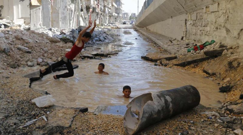 RNPS - REUTERS NEWS PICTURE SERVICE - PICTURES OF THE YEAR 2014
A youth dives into a crater filled with water in Aleppo's al-Shaar district, in this July 10, 2014 file photo.  REUTERS/Hosam Katan/Files (SYRIA - Tags: CIVIL UNREST CONFLICT SOCIETY TPX IMAGES OF THE DAY)